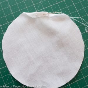 Folded edge of the fabric toward the centre of the circle on the wrong side of the fabric about 7mm image