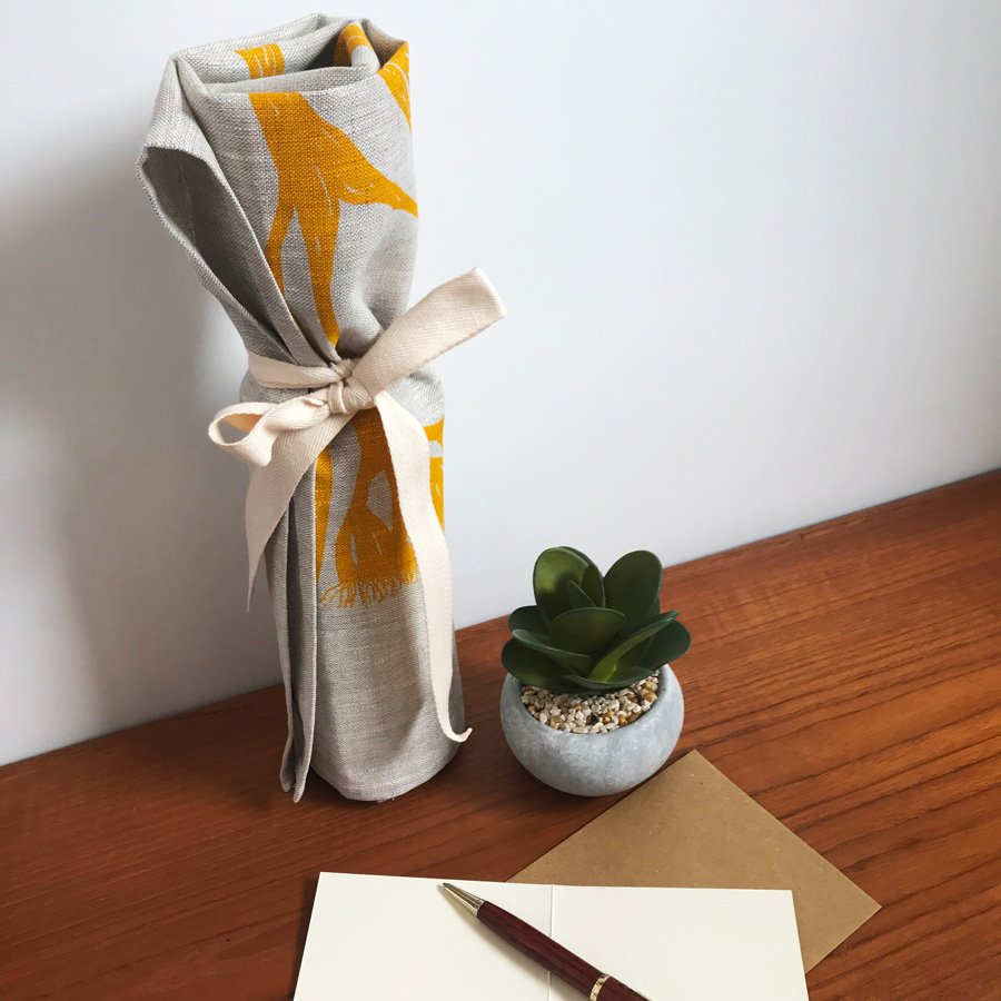 Wrap wine bottle in tea towel