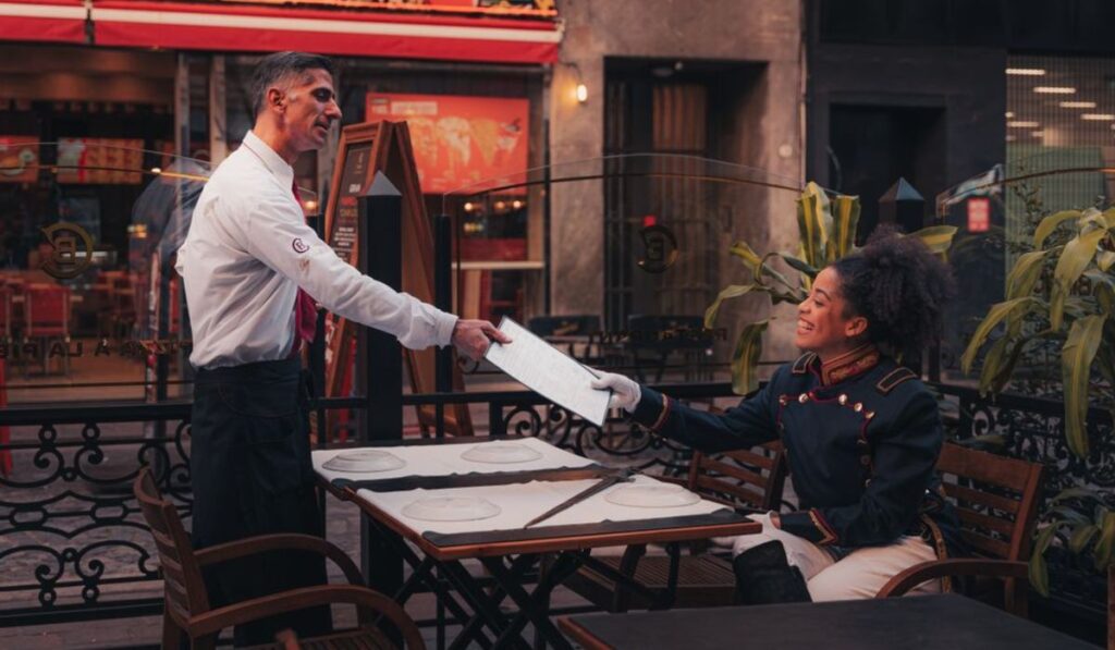 waiter serving menu to client image